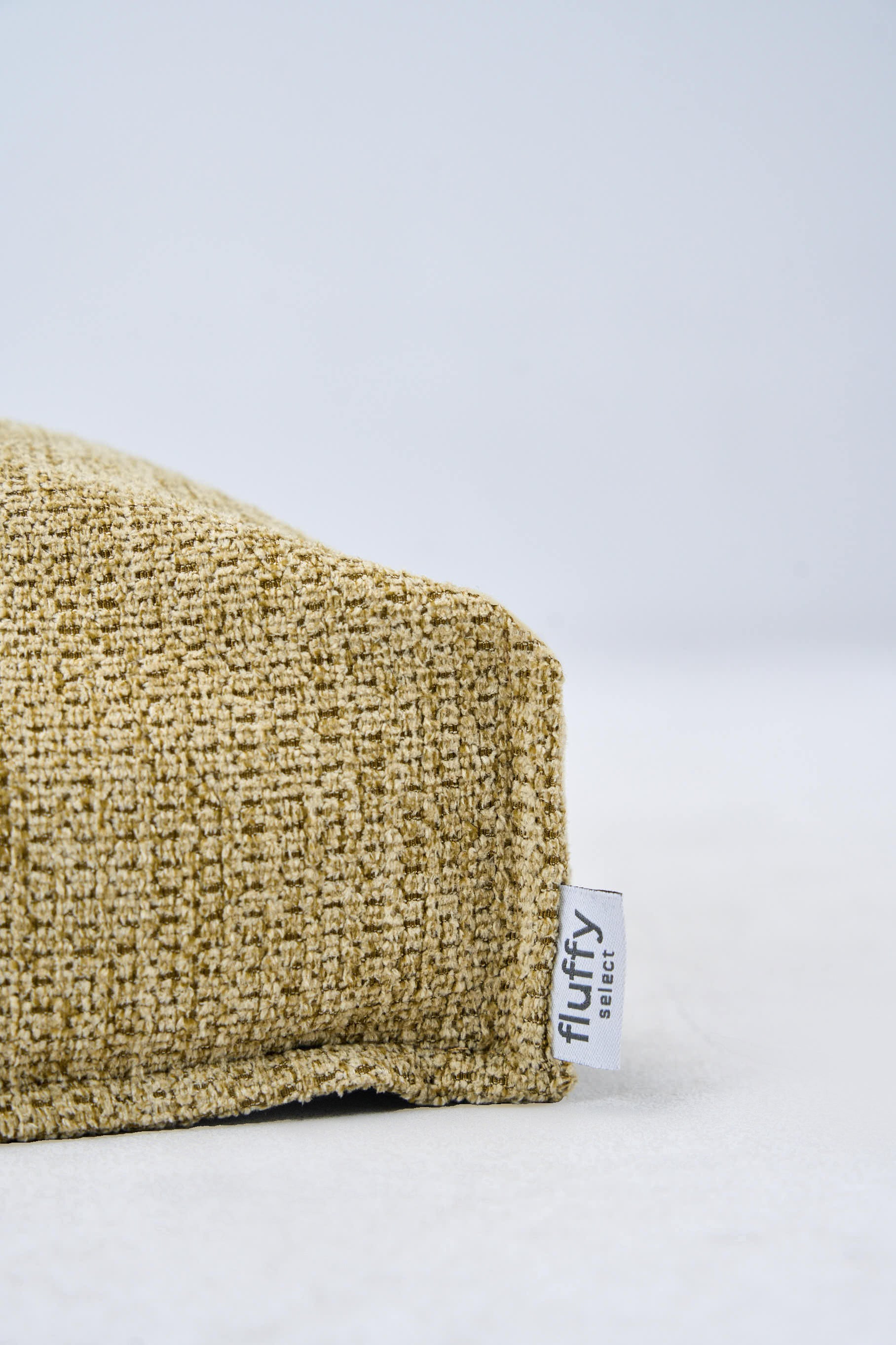 AirNest dog bed in lemongrass woven fabric with side brand tag