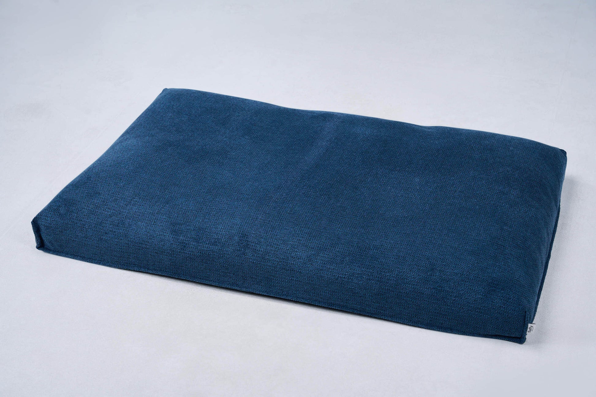 AirNest dog bed cushion in ocean blue fabric with corner ties