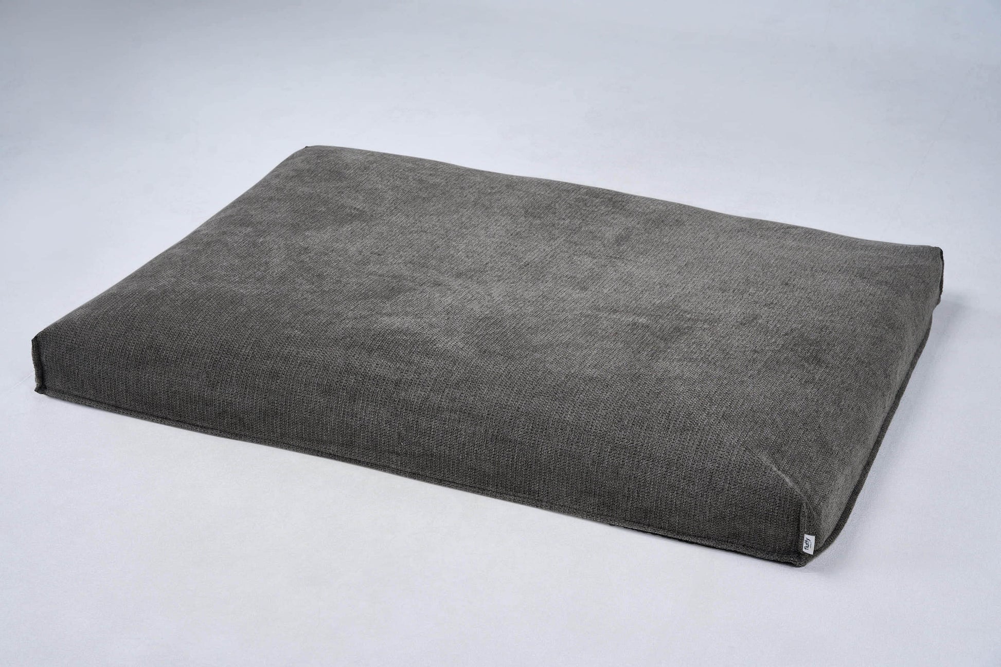 AirNest dog bed cushion in medium gray fabric with corner ties