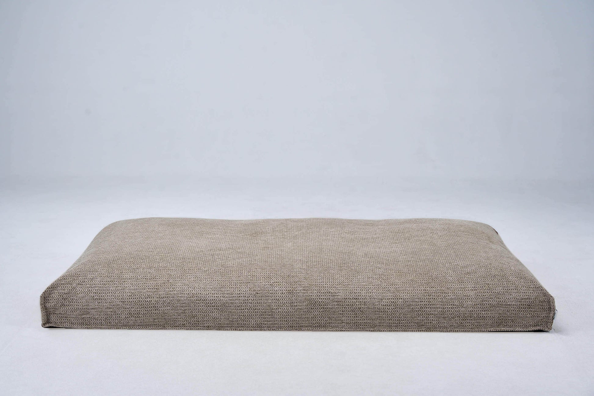 Dog bed cushion in light beige with flat top and stitched edges