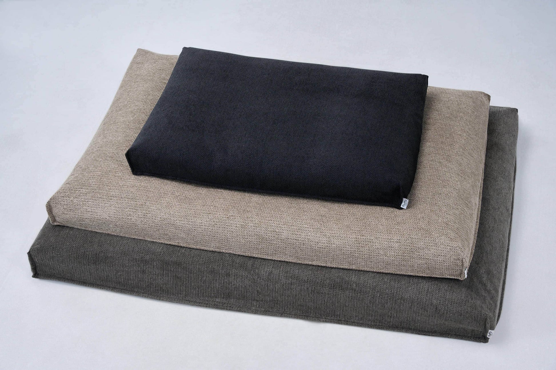 Dog bed set with beige base cushion and dark top cushion