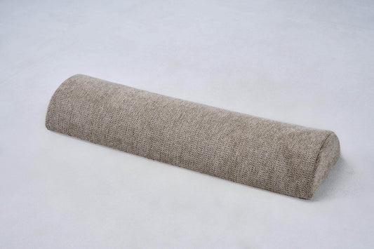 AirNest pillow in textured anthracite-gray fabric, rolled bolster shape