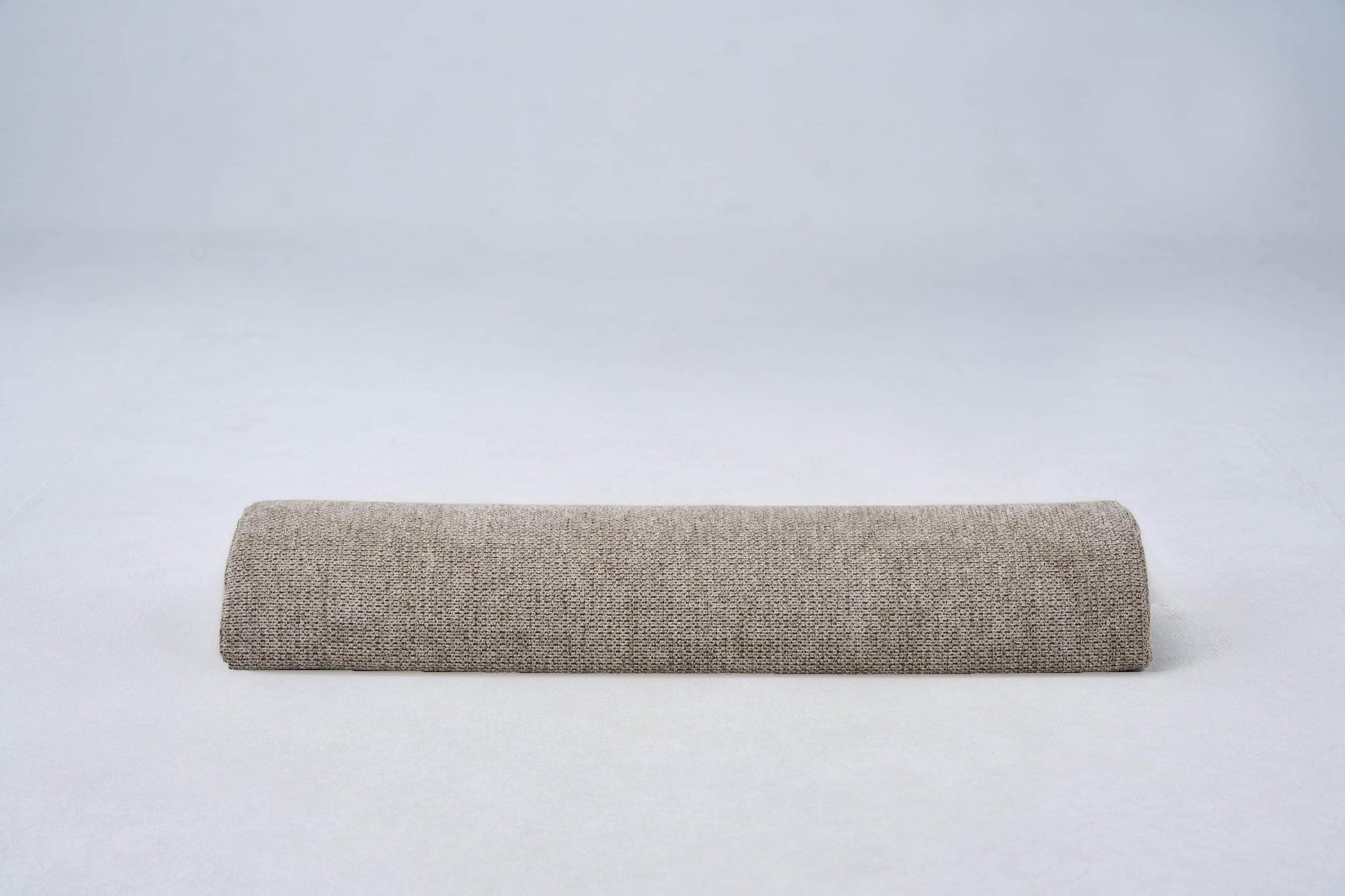 AirNest pillow in textured anthracite-gray fabric, side view bolster